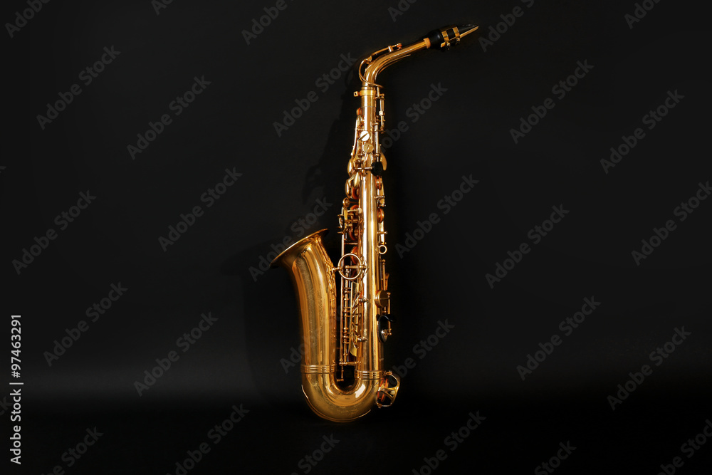 Fototapeta premium Beautiful golden saxophone on black background