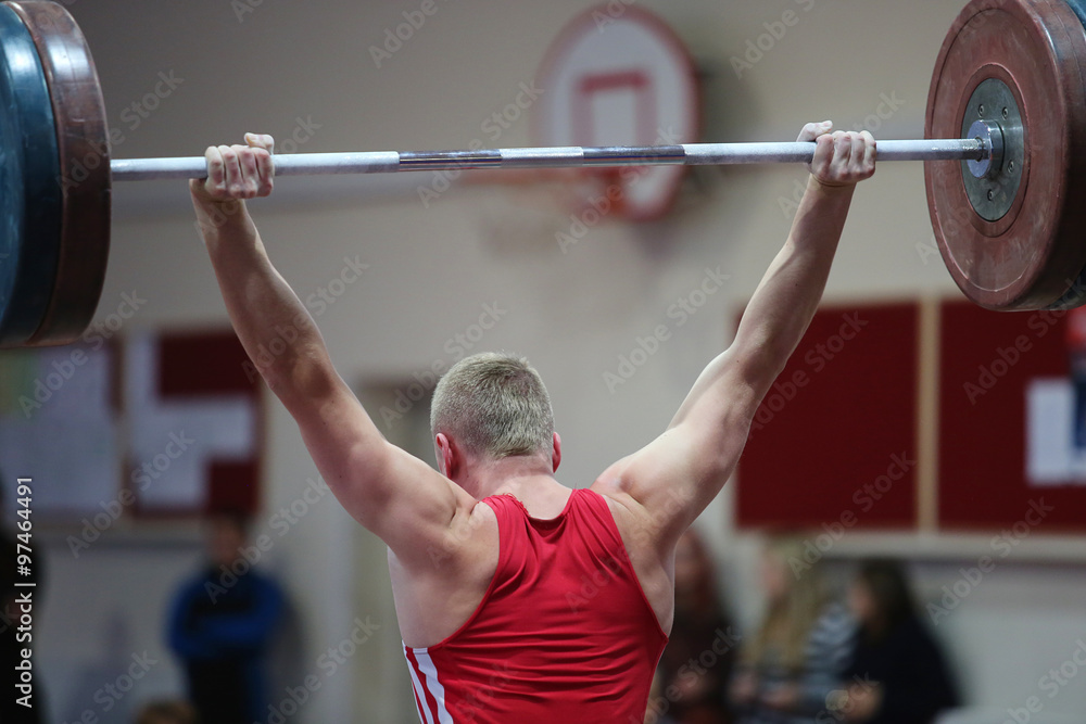 Fototapeta premium athlete in his attempt to lift the weights