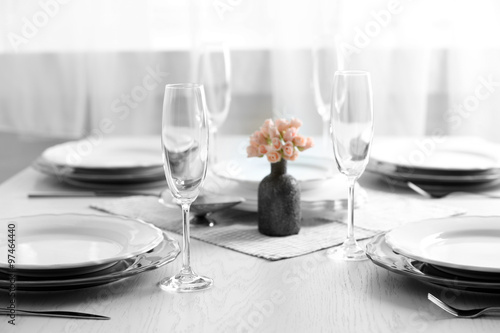 Table set at restaurant on light background