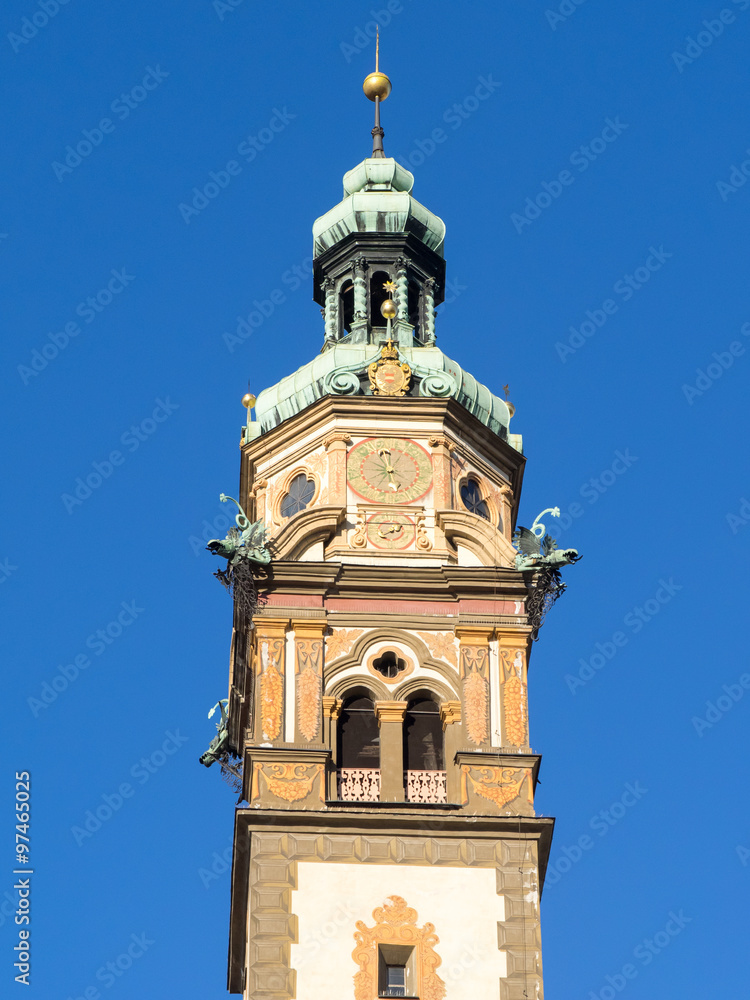 Hall in Tirol, Heart of Jesus church tower bell with blu skt background, vertical frame.