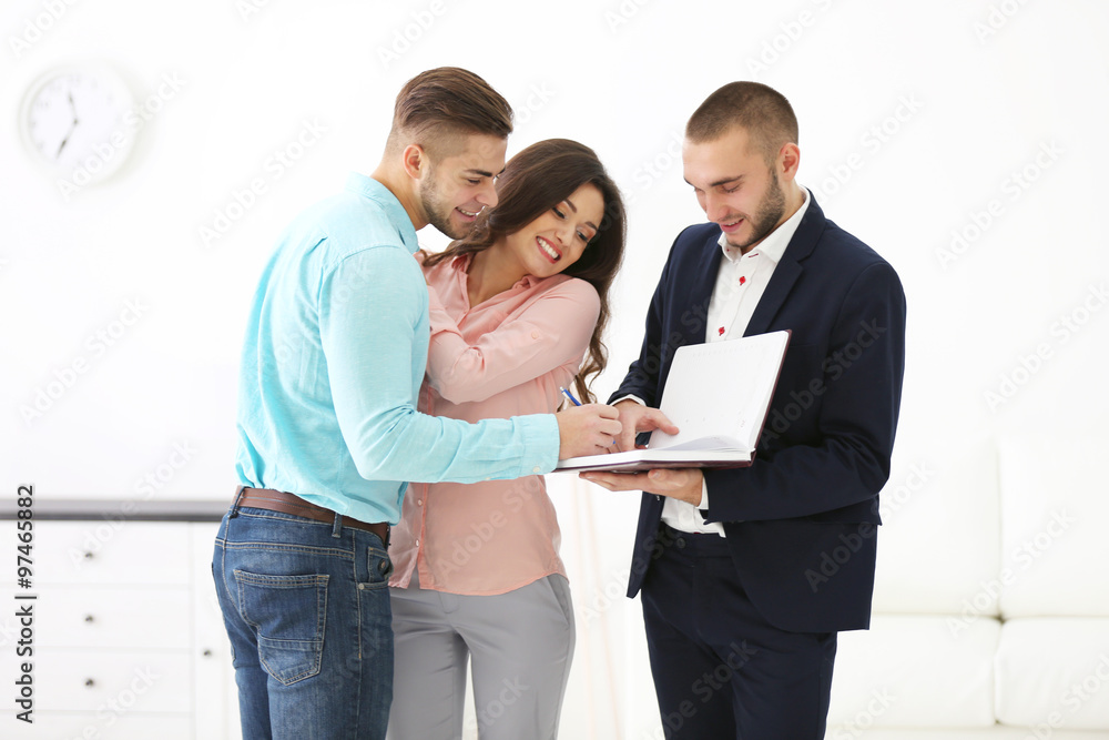 Happy family with estate agent, on light background Happy family with estate agent, on light background