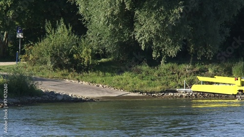 Car ferry arrives at ramp + zoom out river IJssel. Doesburg - Bronkhorst car ferry across the river IJssel in the Netherlands. photo