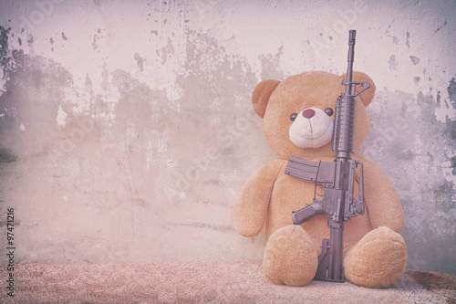 Teddy bear with toy gun