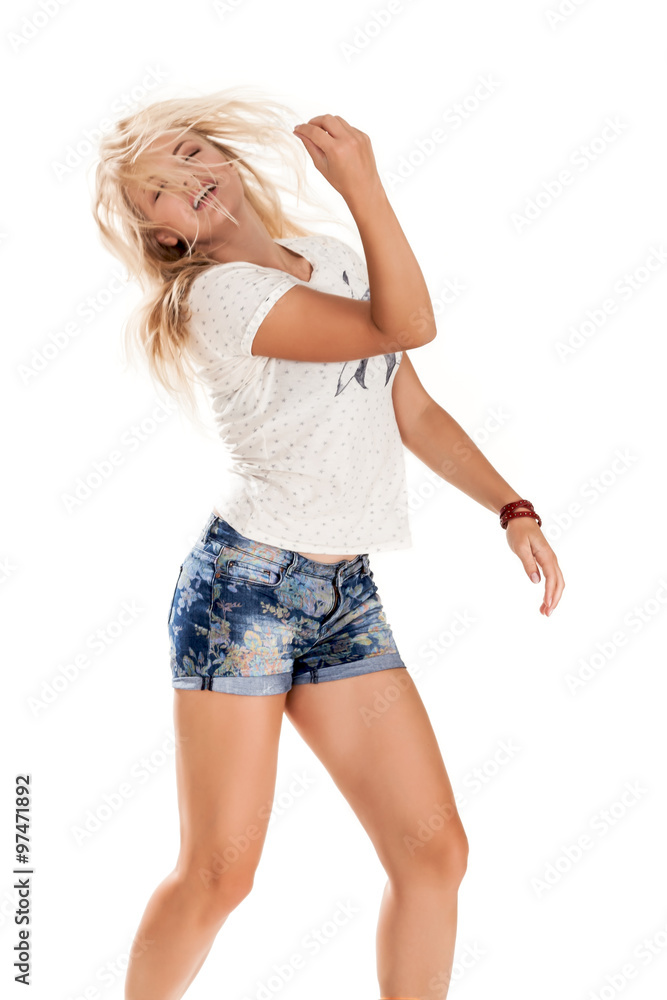 Fototapeta premium cheerful dancing girl jumping short on white background flying hair