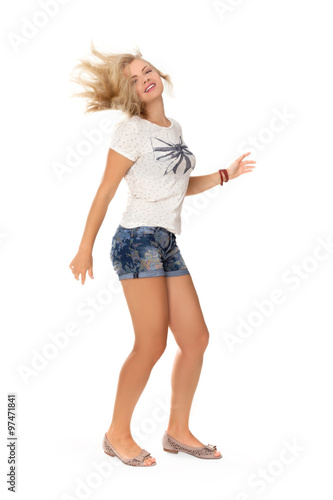 cheerful dancing girl jumping short on white background flying hair
