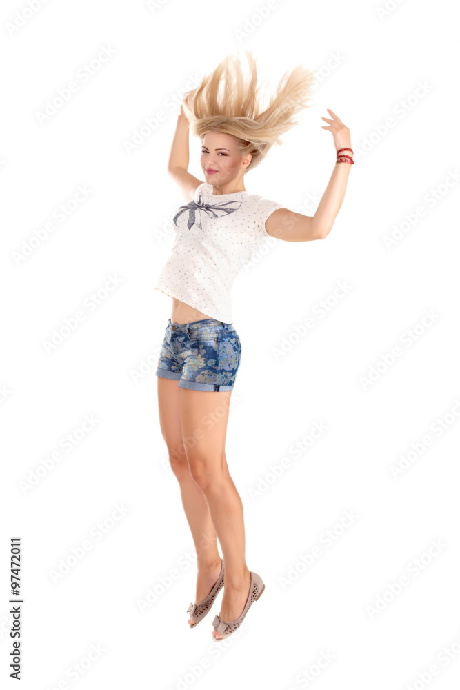 Fototapeta premium cheerful dancing girl jumping short on white background flying hair