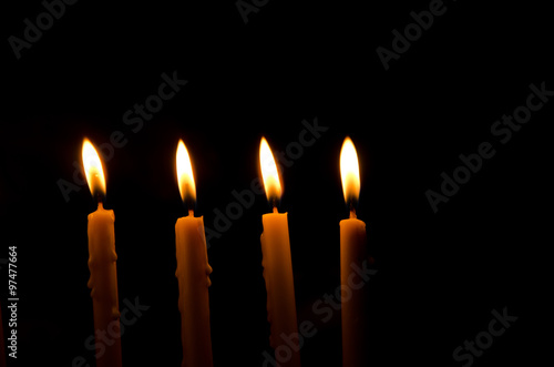 frame light candle burning brightly in the black background