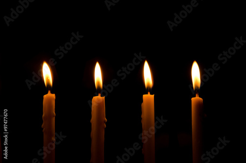 frame light candle burning brightly in the black background