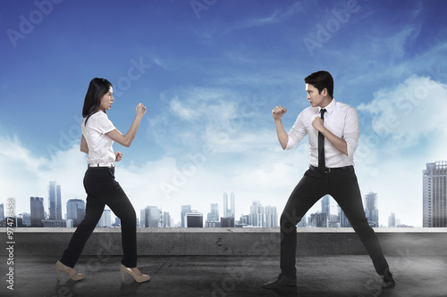 Business man and woman fighting