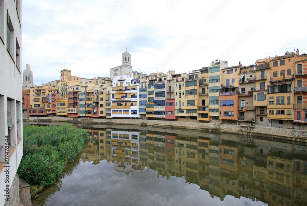 GIRONA, SPAIN - AUGUST 30, 2012: View of the old town with colorful houses on the bank of the river Onyar