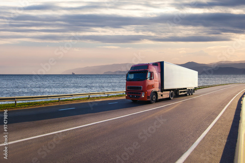 Truck on a road near the sea photo