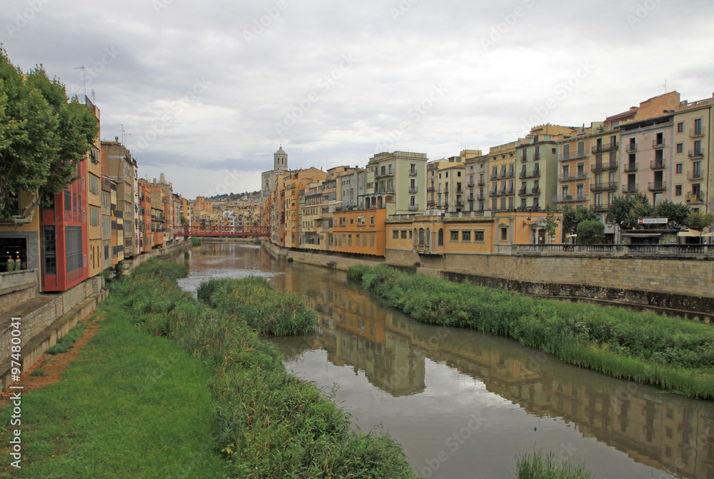 GIRONA, SPAIN - AUGUST 30, 2012: View of the old town with colorful houses on the bank of the river Onyar