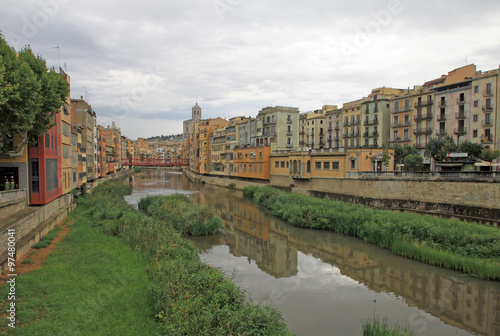 GIRONA, SPAIN - AUGUST 30, 2012: View of the old town with colorful houses on the bank of the river Onyar © shiler_a