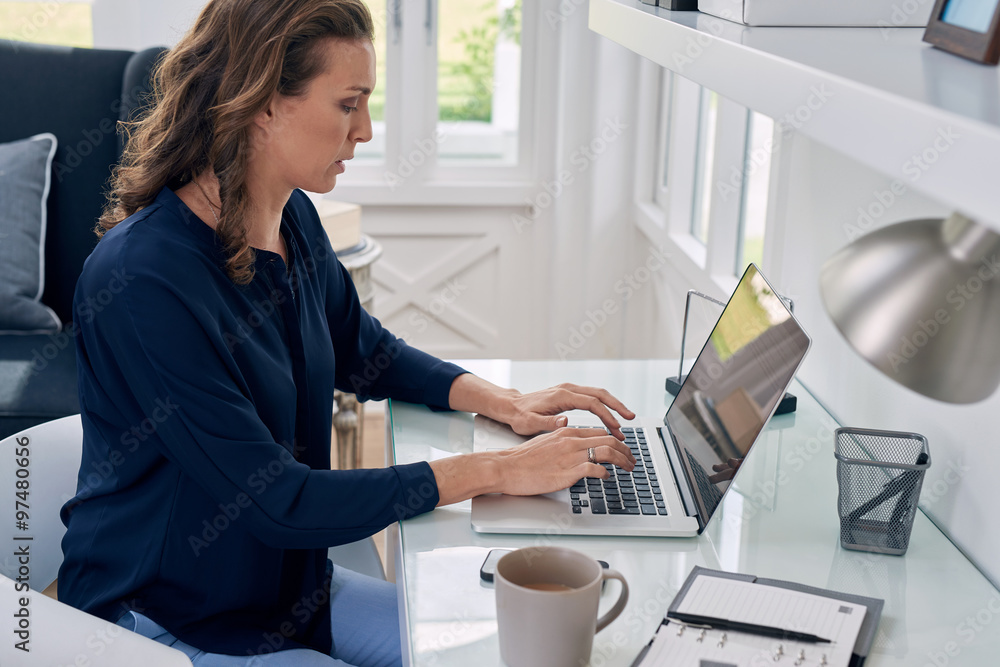 mature woman working from modern home mature woman working from modern home