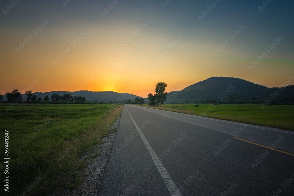 Sunset road at mountains
