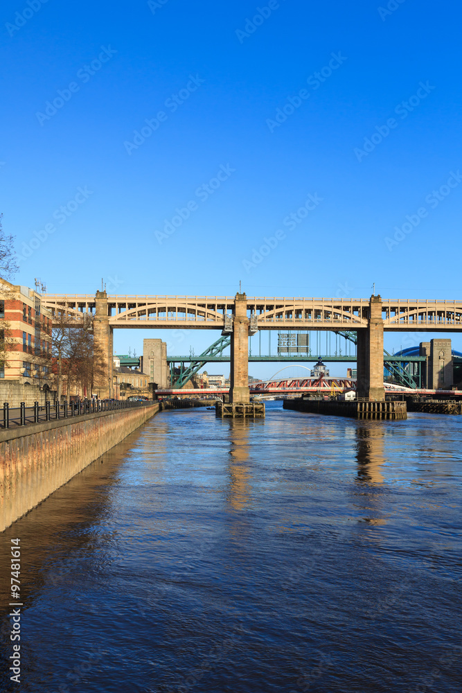 High Level Bridge.  The High Level Bridge is a road and railway bridge spanning the River Tyne between Newcastle upon Tyne and Gateshead in North East England.