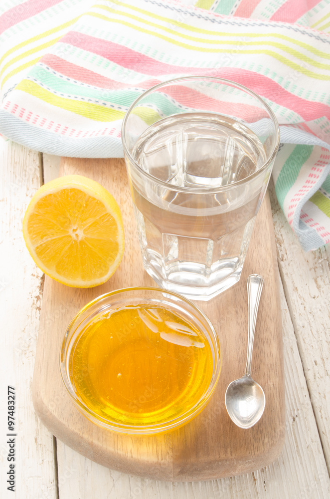 hot water in a glass with lemon and sweet honey hot water in a glass with lemon and sweet honey