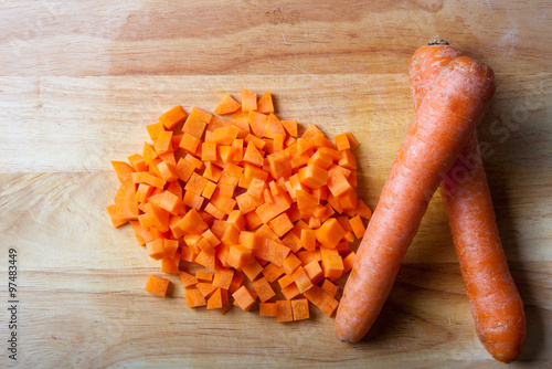Fresh carrot on a light wooden table