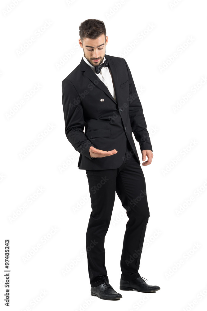 Young groom throwing and playing with wedding ring. Full body length portrait isolated over white studio background. Young groom throwing and playing with wedding ring. Full body length portrait isolated over white studio background.