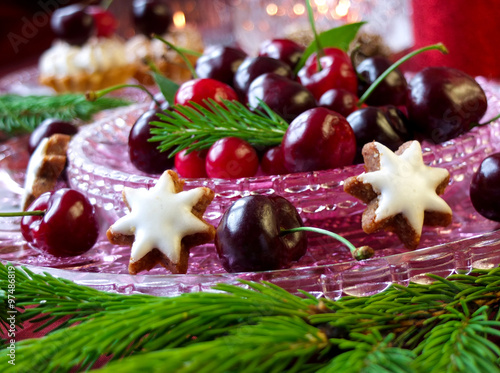 Christmas dessert - red berries cherries, cranberries and christmas tweeg photo