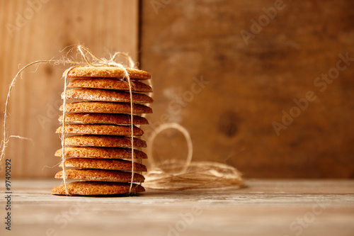 Stack of cookies tied with craft rope on wooden table