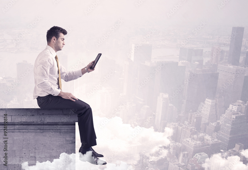Sales person sitting on building edge in city Sales person sitting on building edge in city