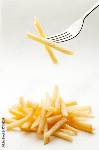 Potatoes fries on a fork