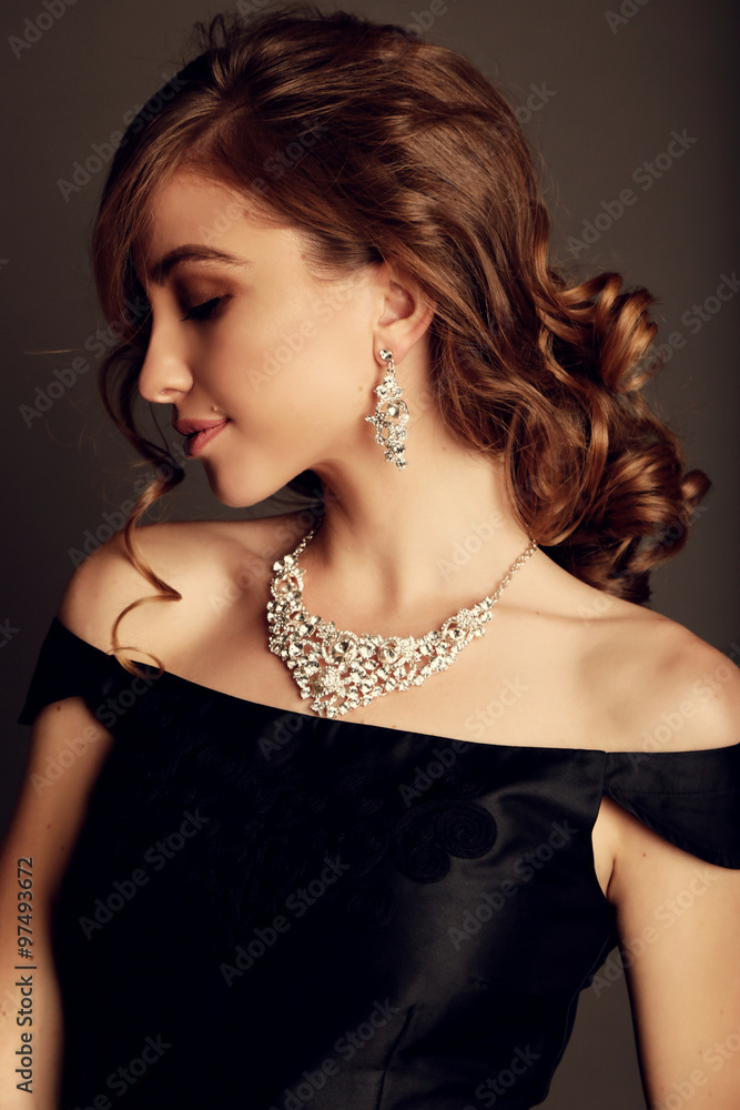 beautiful brunette woman with bijou, wears elegant black dress beautiful brunette woman with bijou, wears elegant black dress
