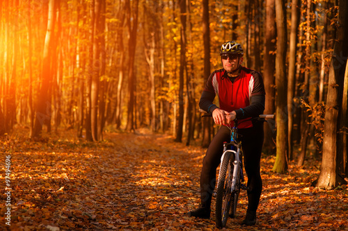 Biker on the forest road riding outdoor