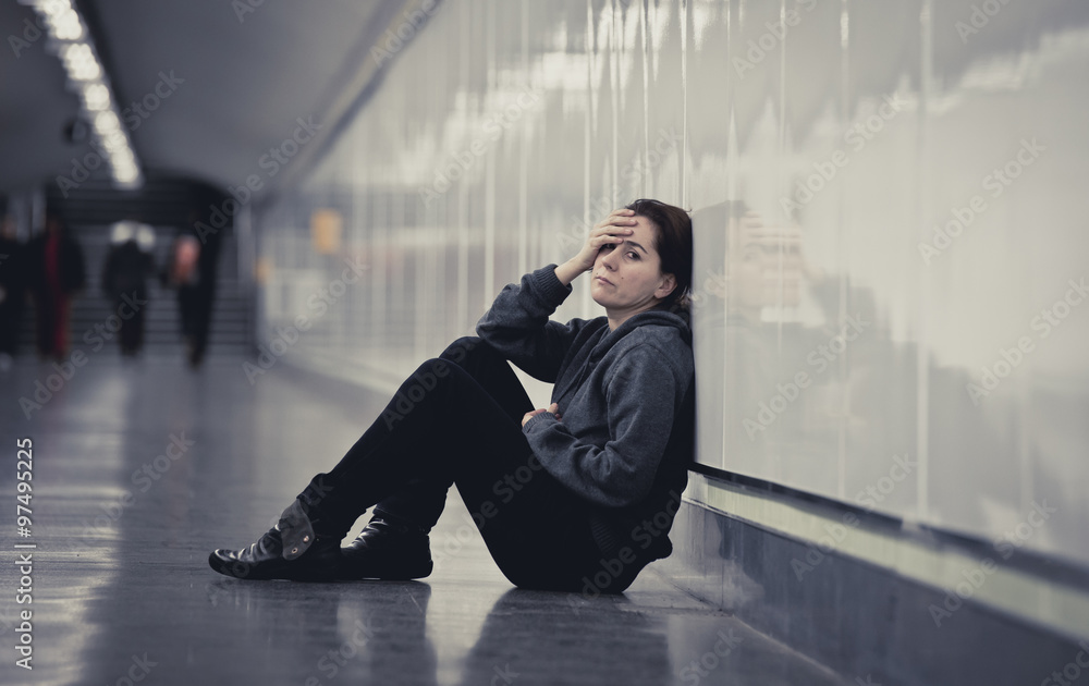 young sad woman in pain alone and depressed at urban subway tunnel ground worried suffering depression young sad woman in pain alone and depressed at urban subway tunnel ground worried suffering depression