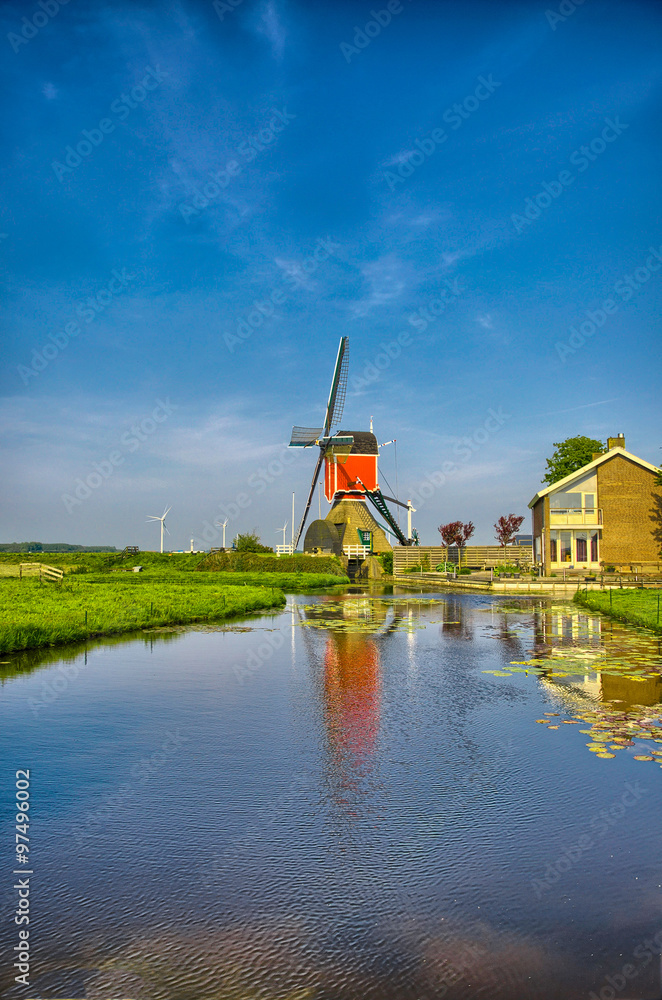 Windmills and water canal in Kinderdijk, Holland or Netherlands.