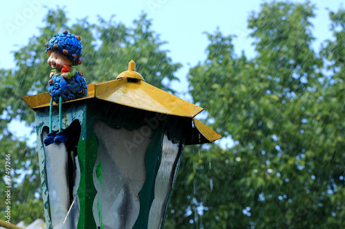 Fototapeta Naklejka Na Ścianę i Meble -  old lantern in the rain retro vintage figure garden