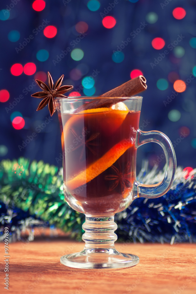mulled wine with tinsel on a wooden table on bokeh background mulled wine with tinsel on a wooden table on bokeh background