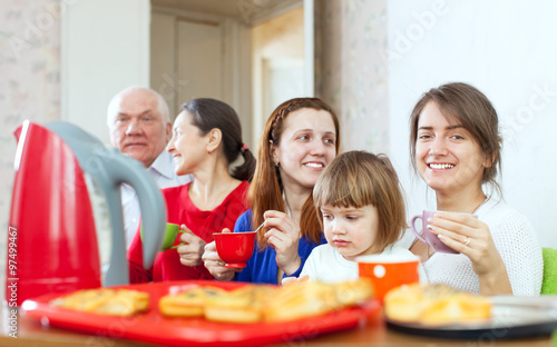 happy multigeneration family communicate over tea