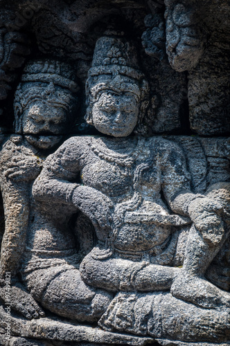 Medidating and sitting Stone carving at buddhist temple Borobudur