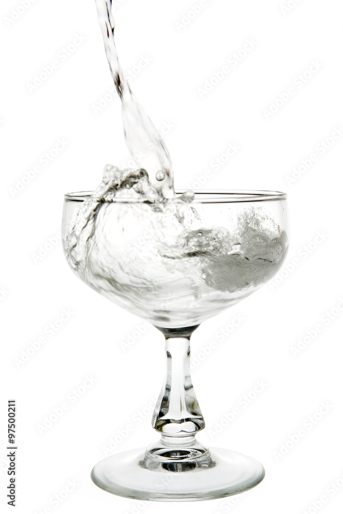 Liquid champagne poured into empty glass on white background. Clipping path incl. Liquid champagne poured into empty glass on white background. Clipping path incl.