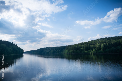 Forest lake with blue sky