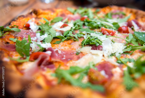 Pizza with dry cured ham and arugula