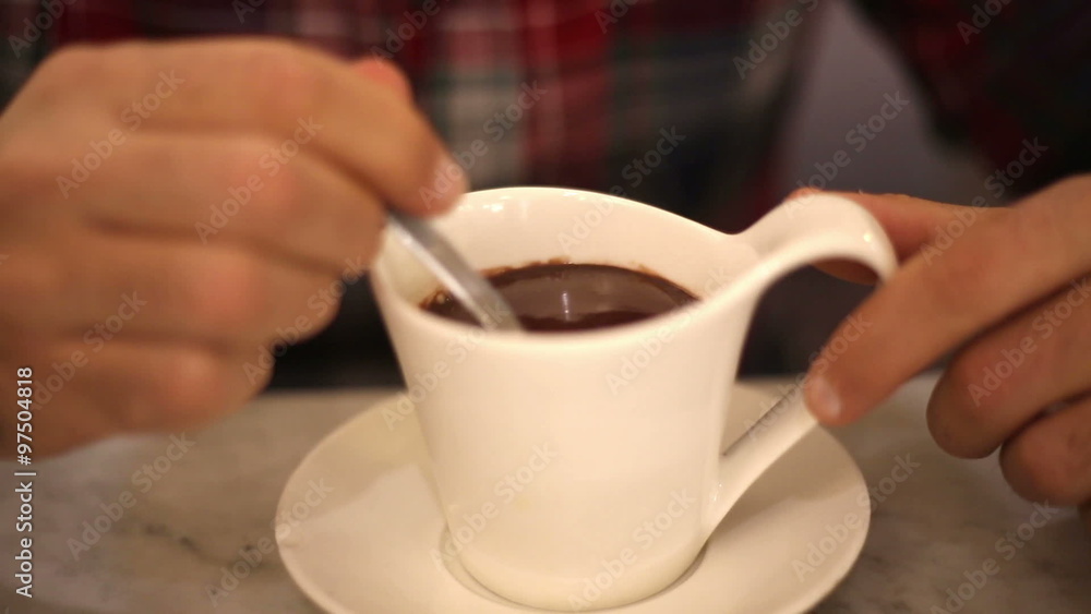 man relaxing in a bar with a hot cup of hot chocolate man relaxing in a bar with a hot cup of hot chocolate