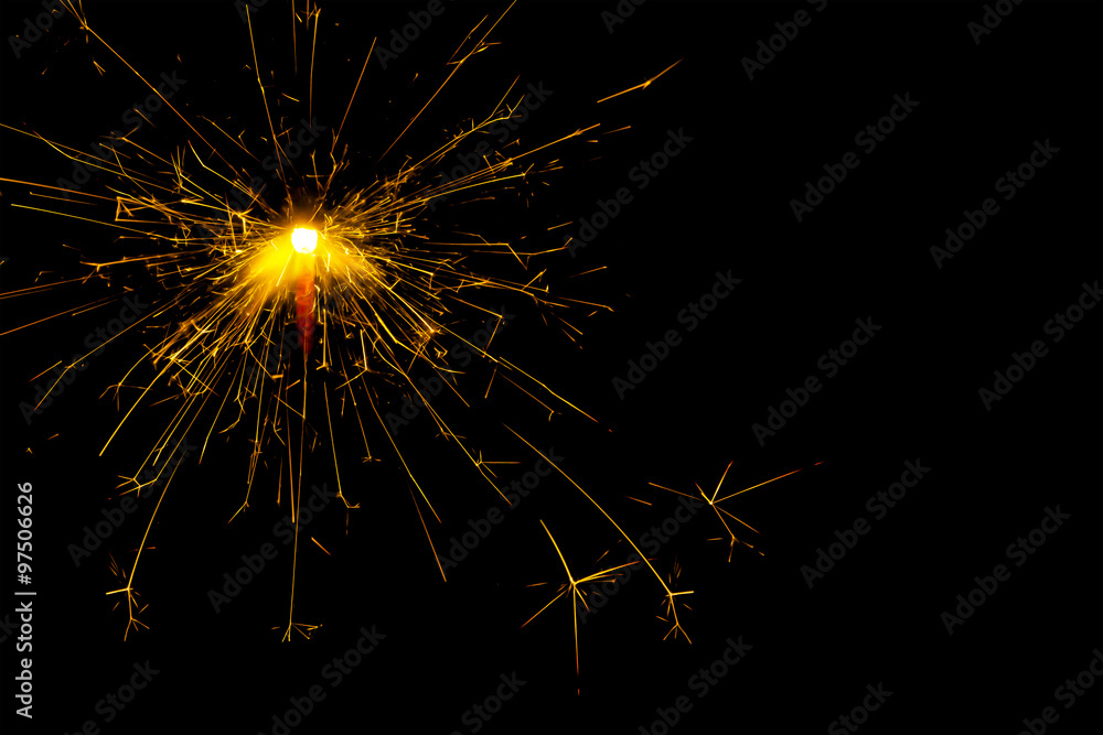 New year and Christmas sparkler on black background. Space for text. New year and Christmas sparkler on black background. Space for text.