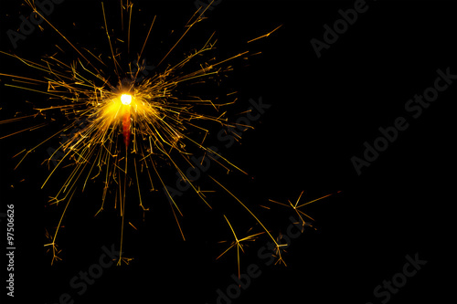 New year and Christmas sparkler on black background. Space for text.