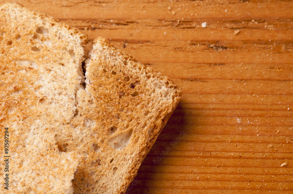 Toast bread slices over wood textured background