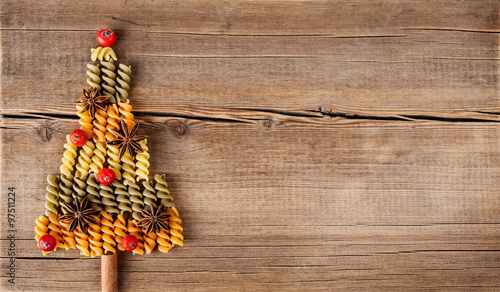 Christmas card with natural decorations on wooden background