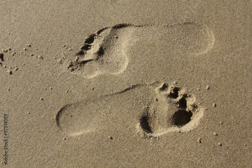 feet steps in sandy beach, jing and jang