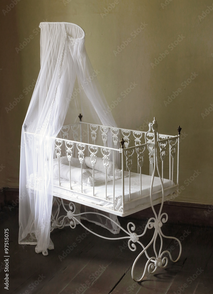 Baby bed. Antique furniture from 19th century. Stock Photo Adobe