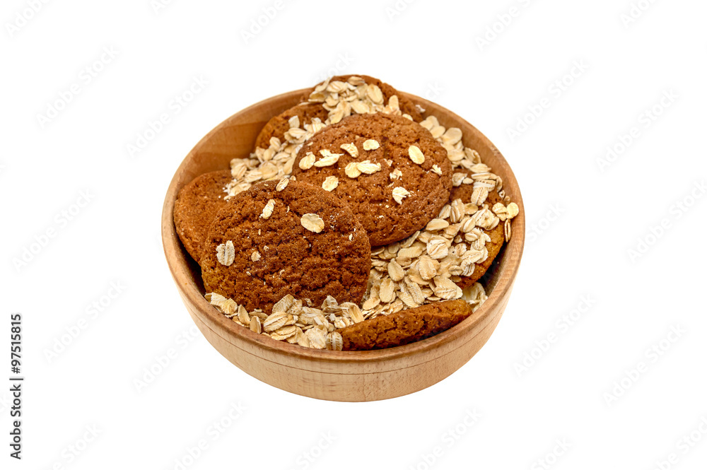 oatmeal and oat cookies in a wooden bowl on a white background oatmeal and oat cookies in a wooden bowl on a white background