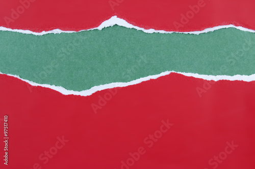 Ripped red paper on green. Christmas background