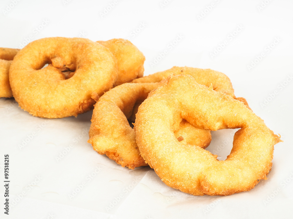 Closeup of doughnuts in pile on baking paper Closeup of doughnuts in pile on baking paper