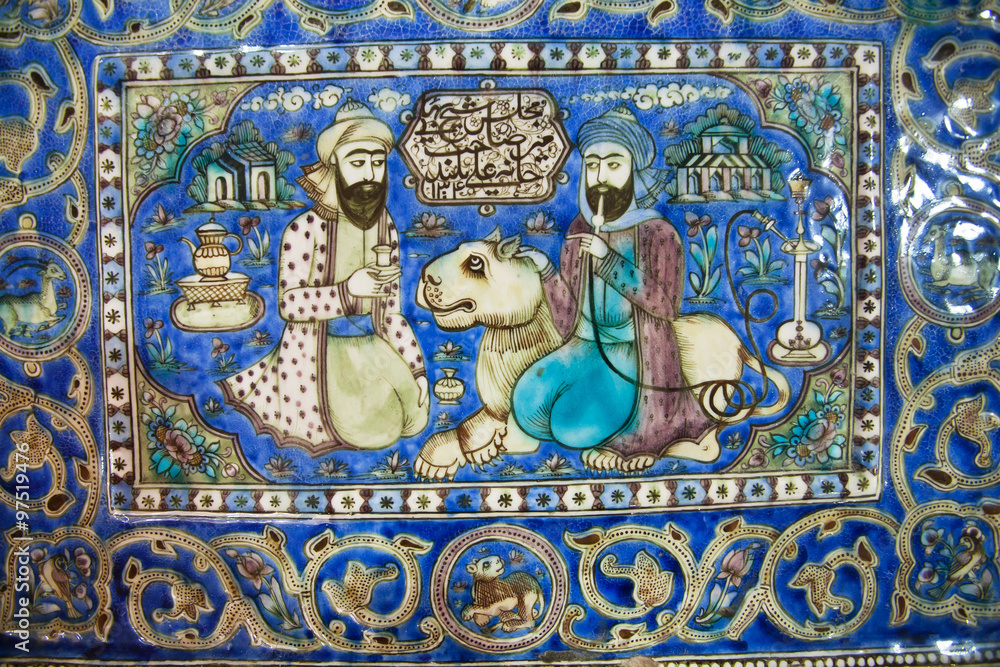 Ceramic tiles of 19th century with a lion and two persian men talking in garden