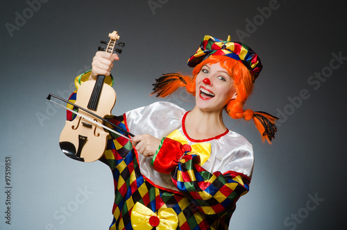 Clown in funny concept on dark background